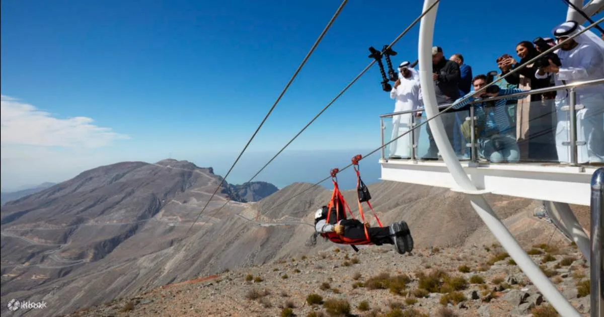 A zipliner launching from the Jebel Jais viewing platform above the mountains