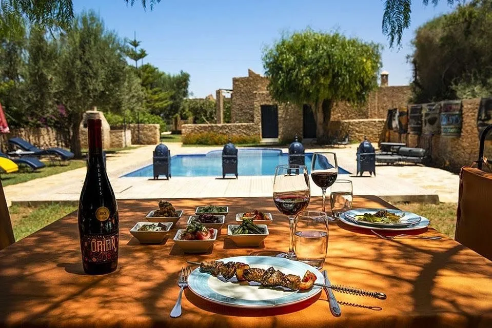 Lunch and red wine served poolside at Val d’Argan near Essaouira