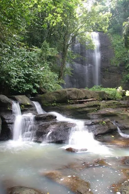 Toraille Waterfall tumbling over mossy rocks into a pool